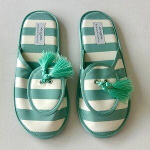 Aquazzura women’s lounge slippers in an aqua-green and white striped design.